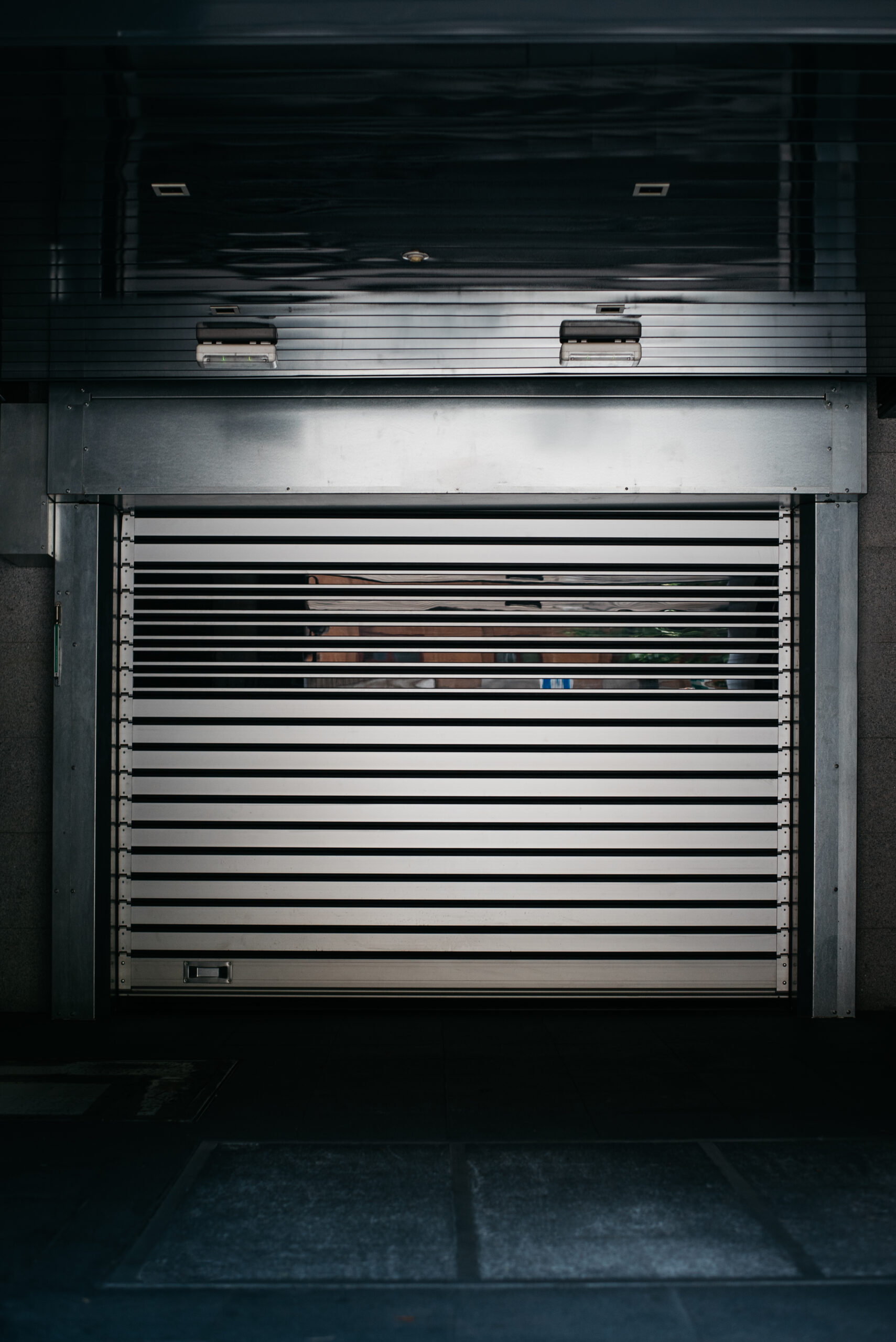 Closed metal roller shutter door on a building