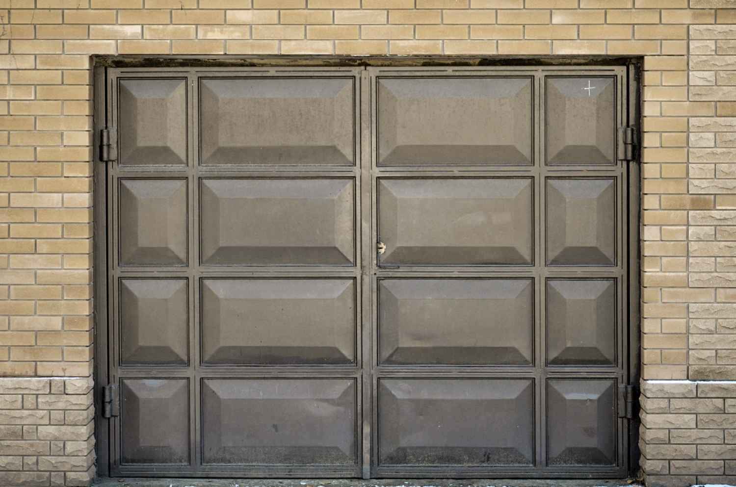 A large, rectangular, dark gray garage door with raised panels.