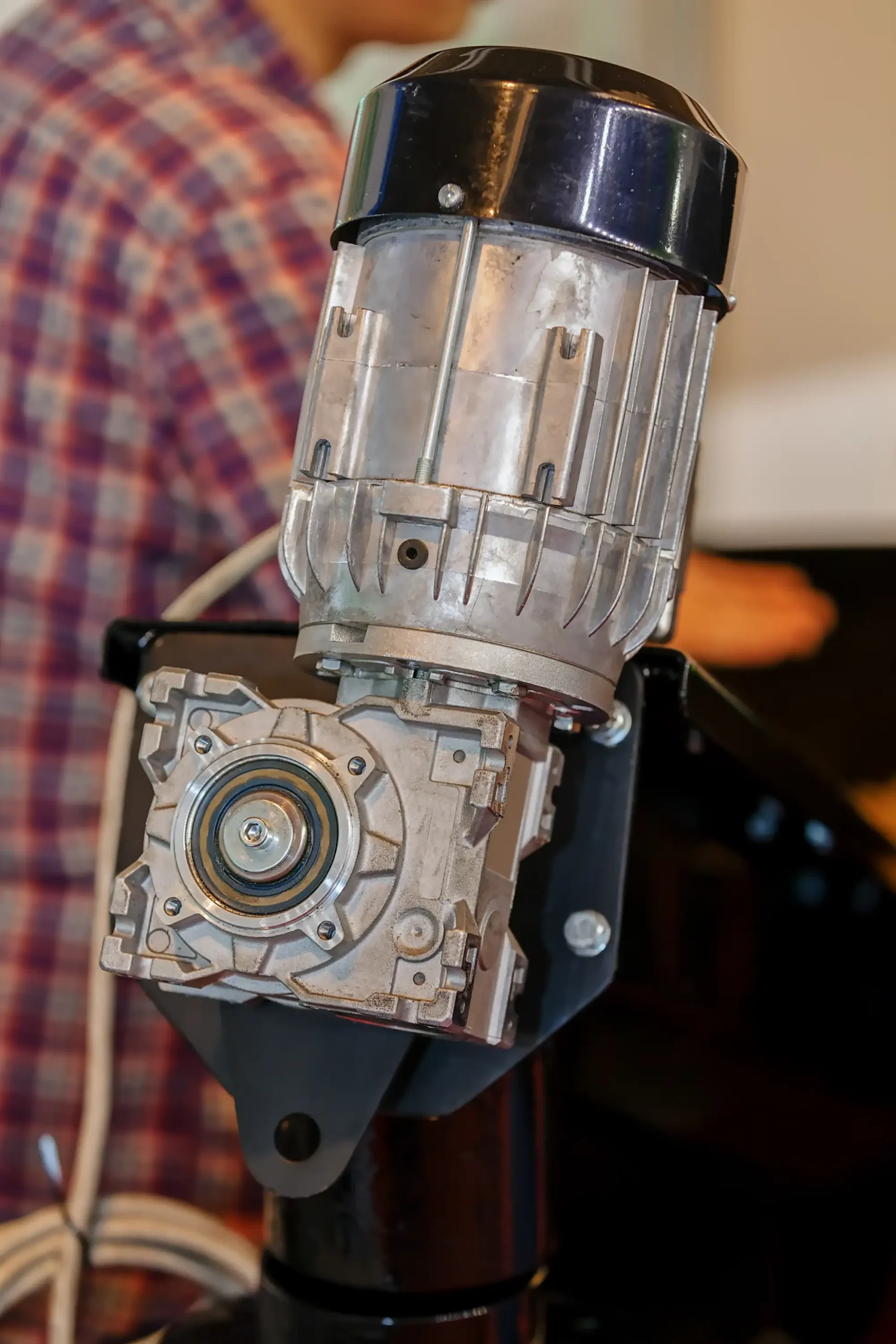 Close-up of a silver industrial motor with a black top.