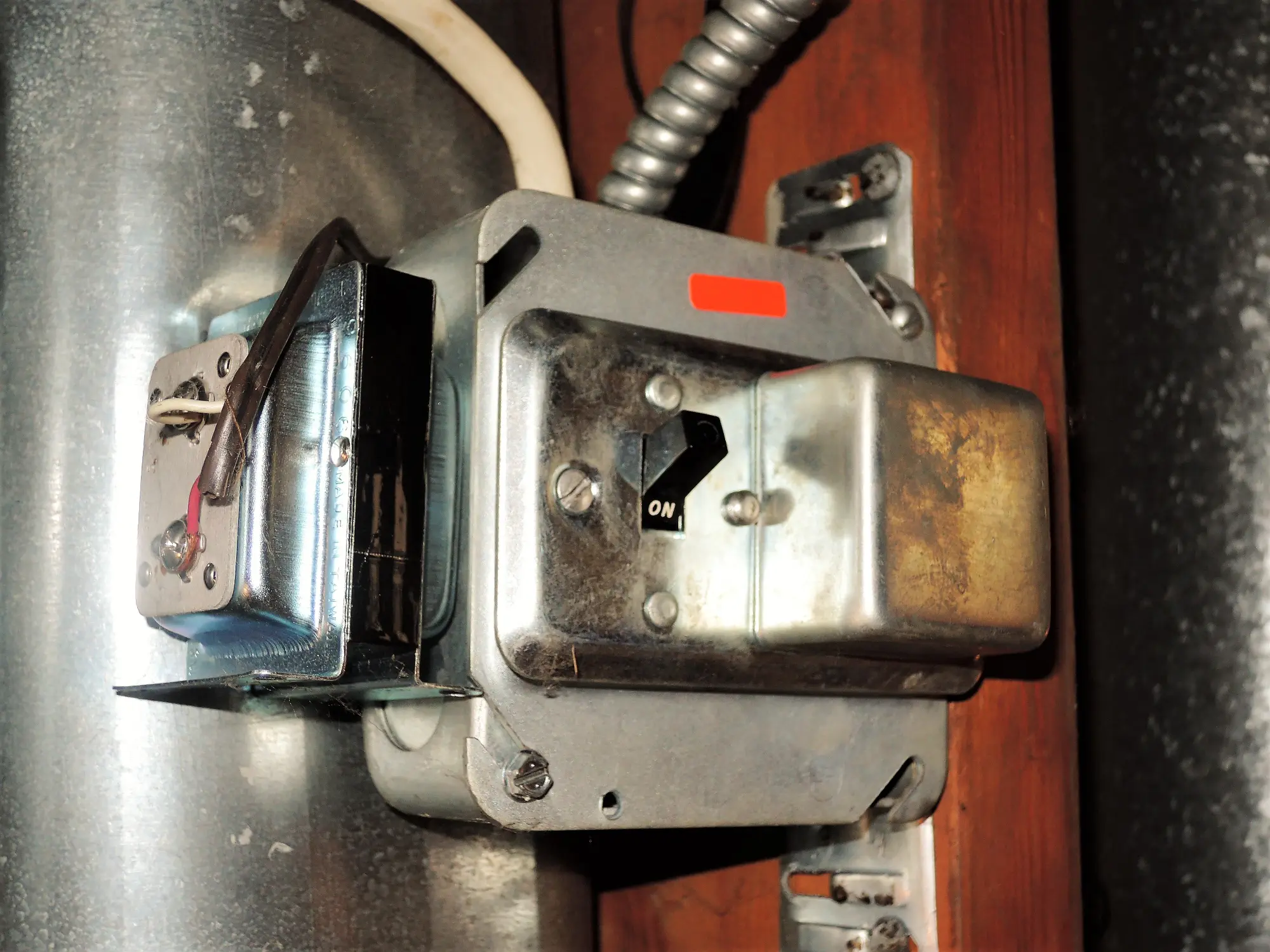 Close-up of an electrical transformer with an 'ON' switch.